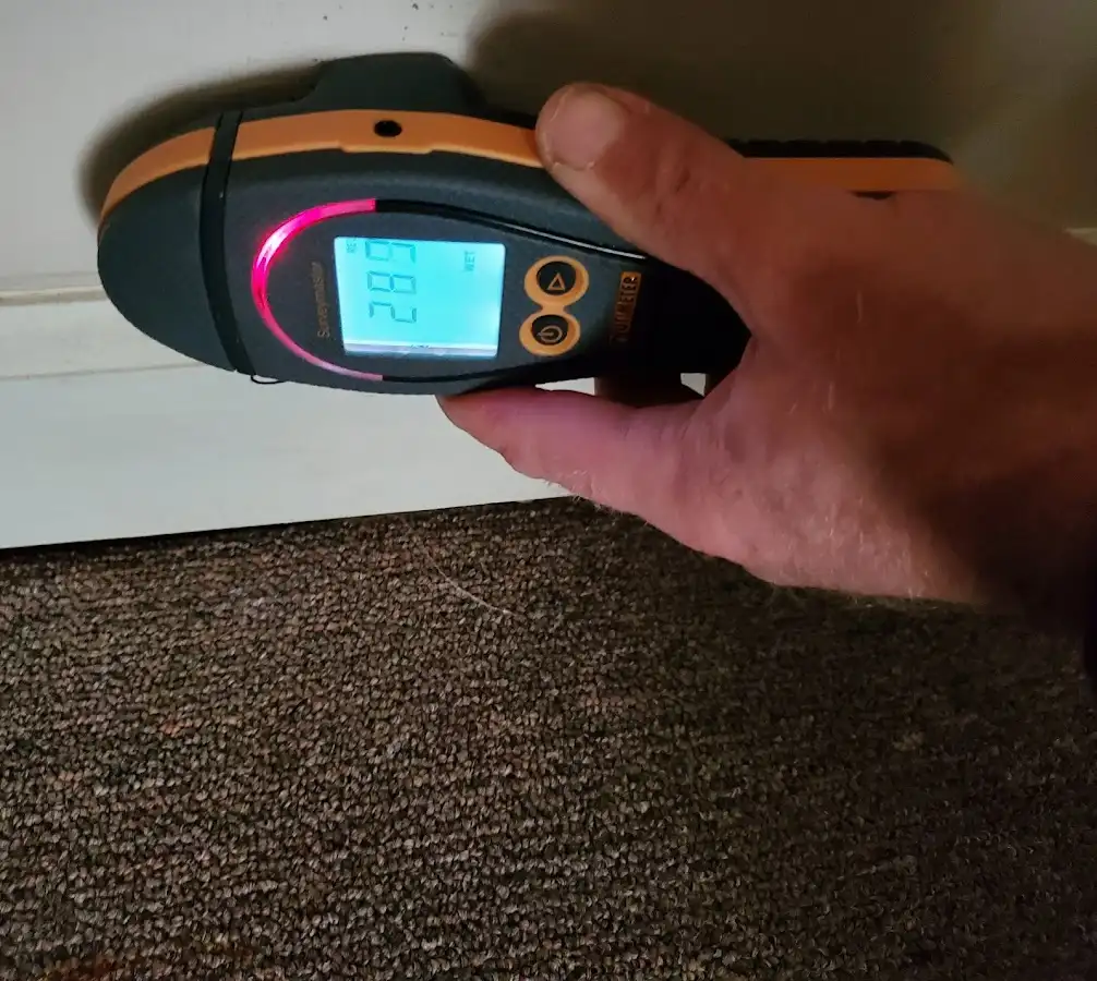 Moisture detection at baseboard during Storm Damage Restoration in Carrollton